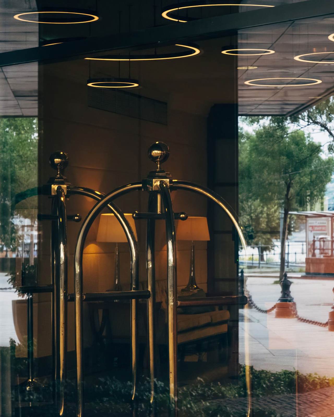 Brass luggage cart in a sunlit hotel lobby