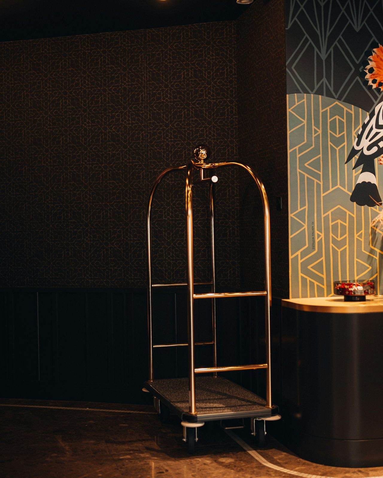 Brass luggage cart in a styled lobby