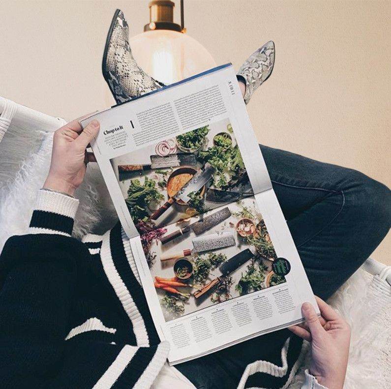 Reader holding an open magazine feature