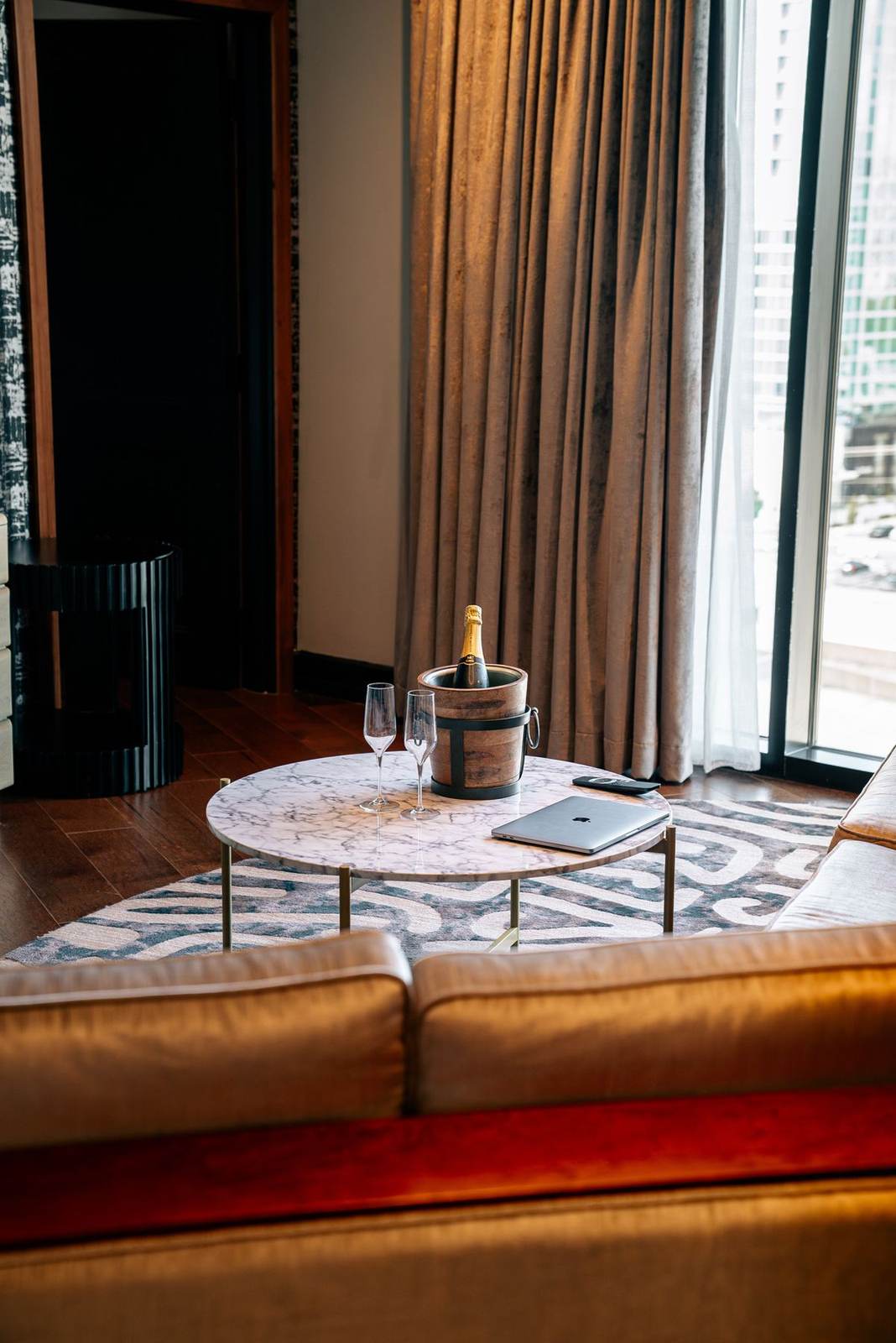 Lounge seating beside tall windows